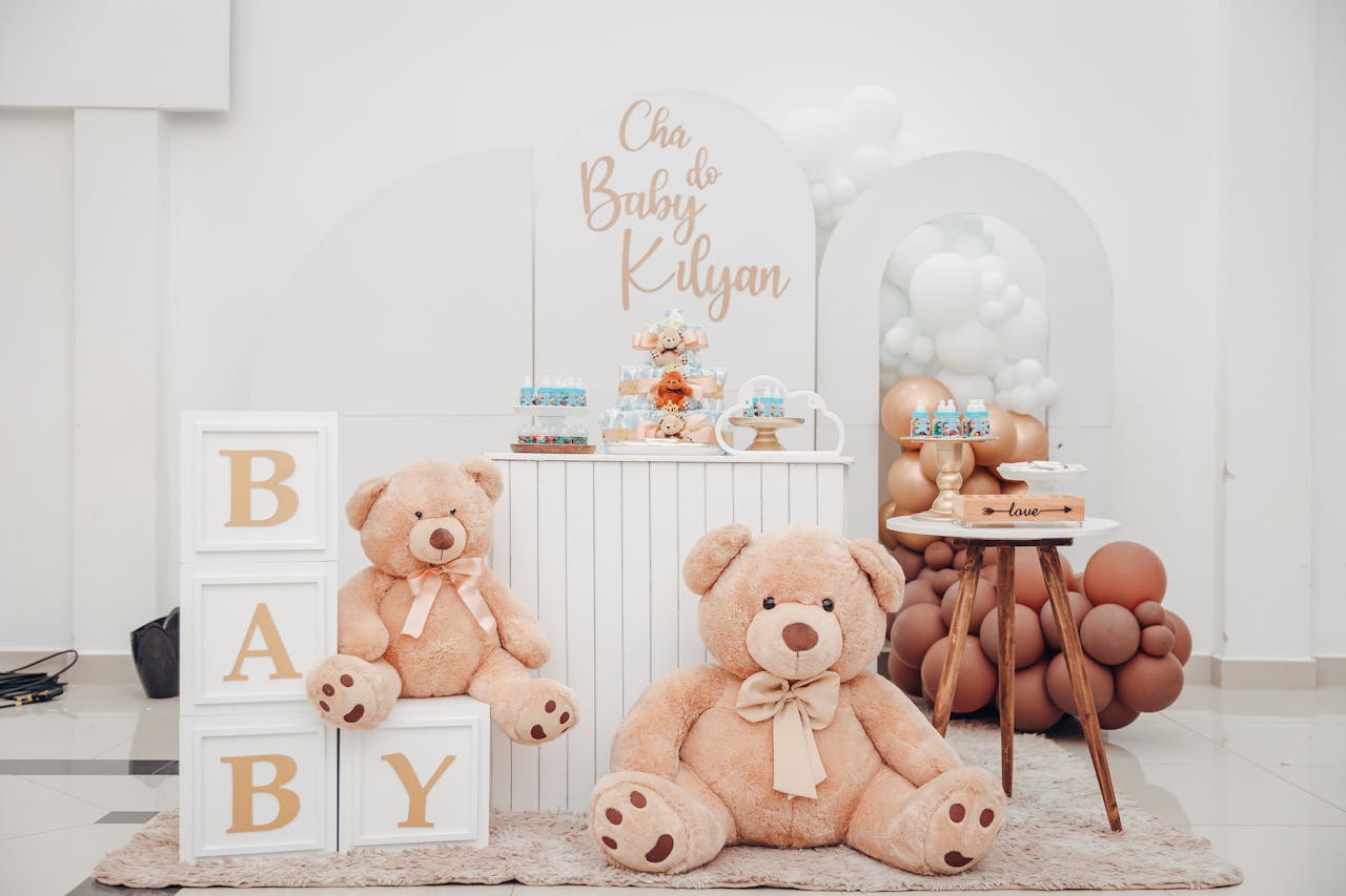 Soft and inviting baby shower setup featuring beige teddy bears and balloon decor.